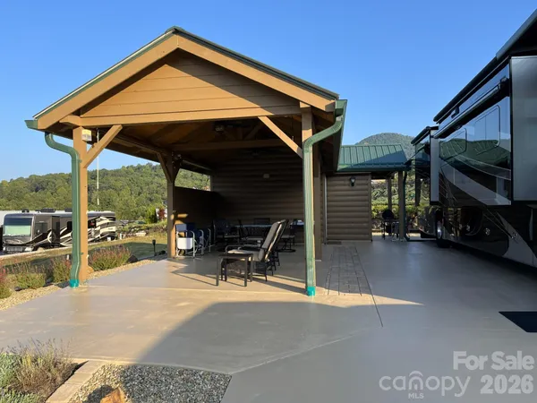 a dining room with furniture and a floor to ceiling window