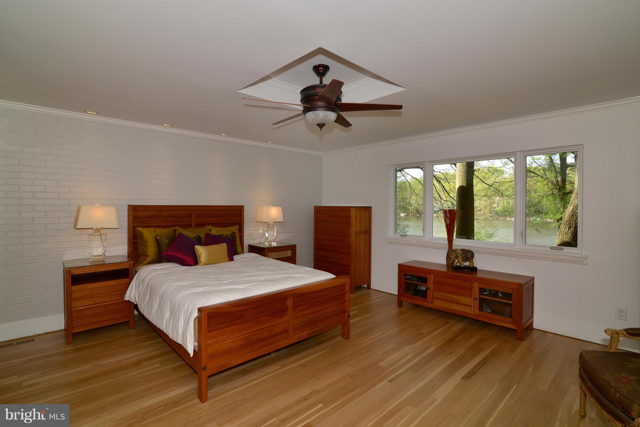 11316 South Shore Road Reston, VA 20190 - Photo 13 of 29 a bedroom with a bed and a large window