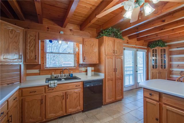 51 Cages Bend Lane Riddleton, TN 37151 - Photo 11 of 20 a kitchen with granite countertop a sink stove and refrigerator