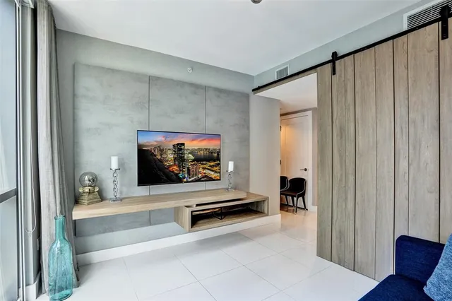 a bedroom with a large bed and a large window