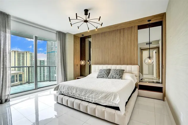 a bedroom with furniture and a flat screen tv