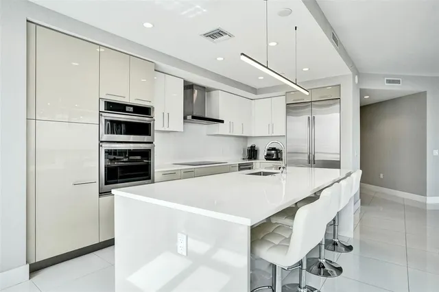a kitchen with white cabinets and white appliances