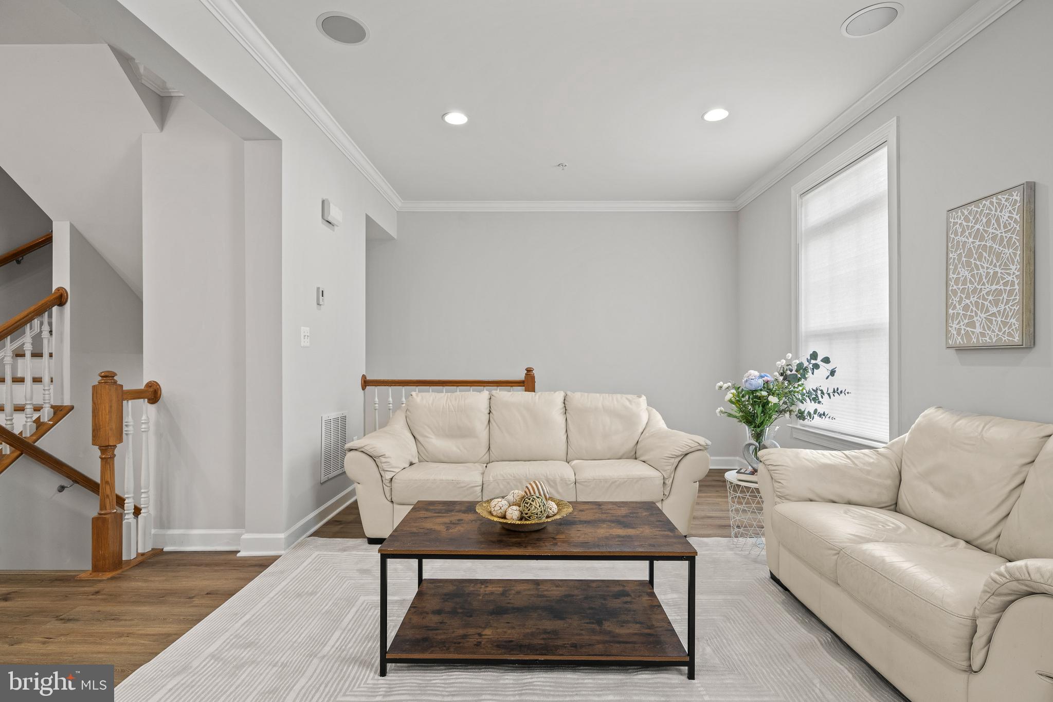 7704 Water Street Fulton, MD 20759 - Photo 13 of 45 a living room with furniture a rug and a flat screen tv