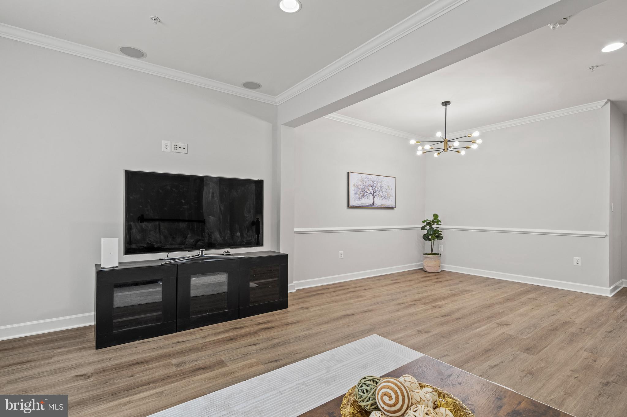 7704 Water Street Fulton, MD 20759 - Photo 14 of 45 a view of a livingroom with wooden floor and a flat screen tv