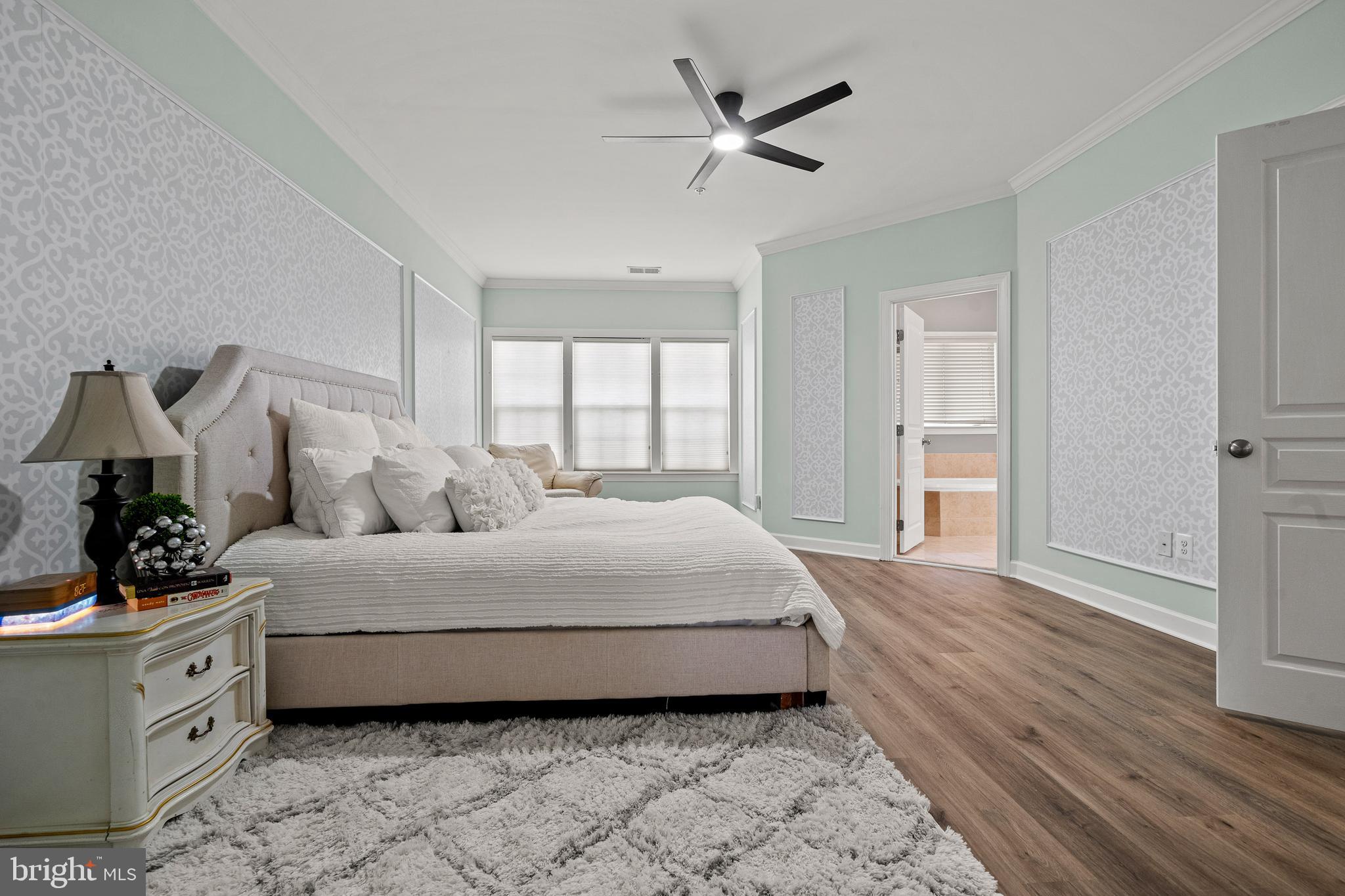 7704 Water Street Fulton, MD 20759 - Photo 18 of 45 a spacious bedroom with a bed and a potted plant