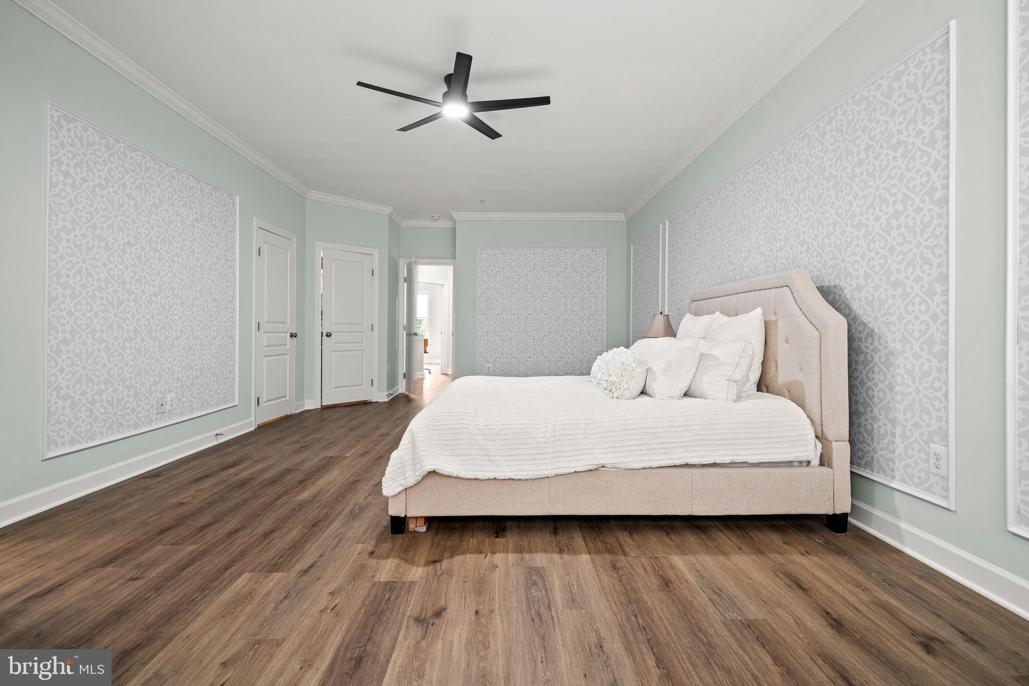 7704 Water Street Fulton, MD 20759 - Photo 20 of 45 a spacious bedroom with a bed and a ceiling fan