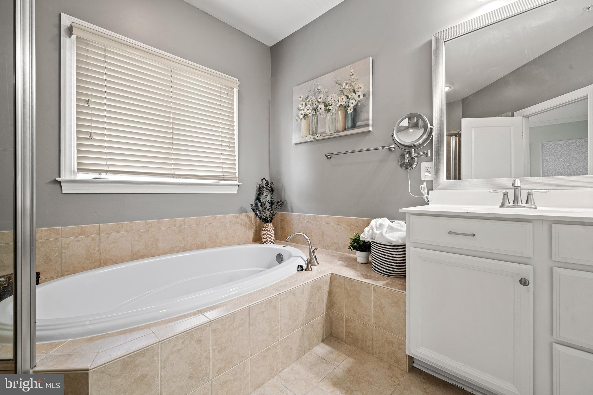 7704 Water Street Fulton, MD 20759 - Photo 24 of 45 a bathroom with a bathtub a sink and a window