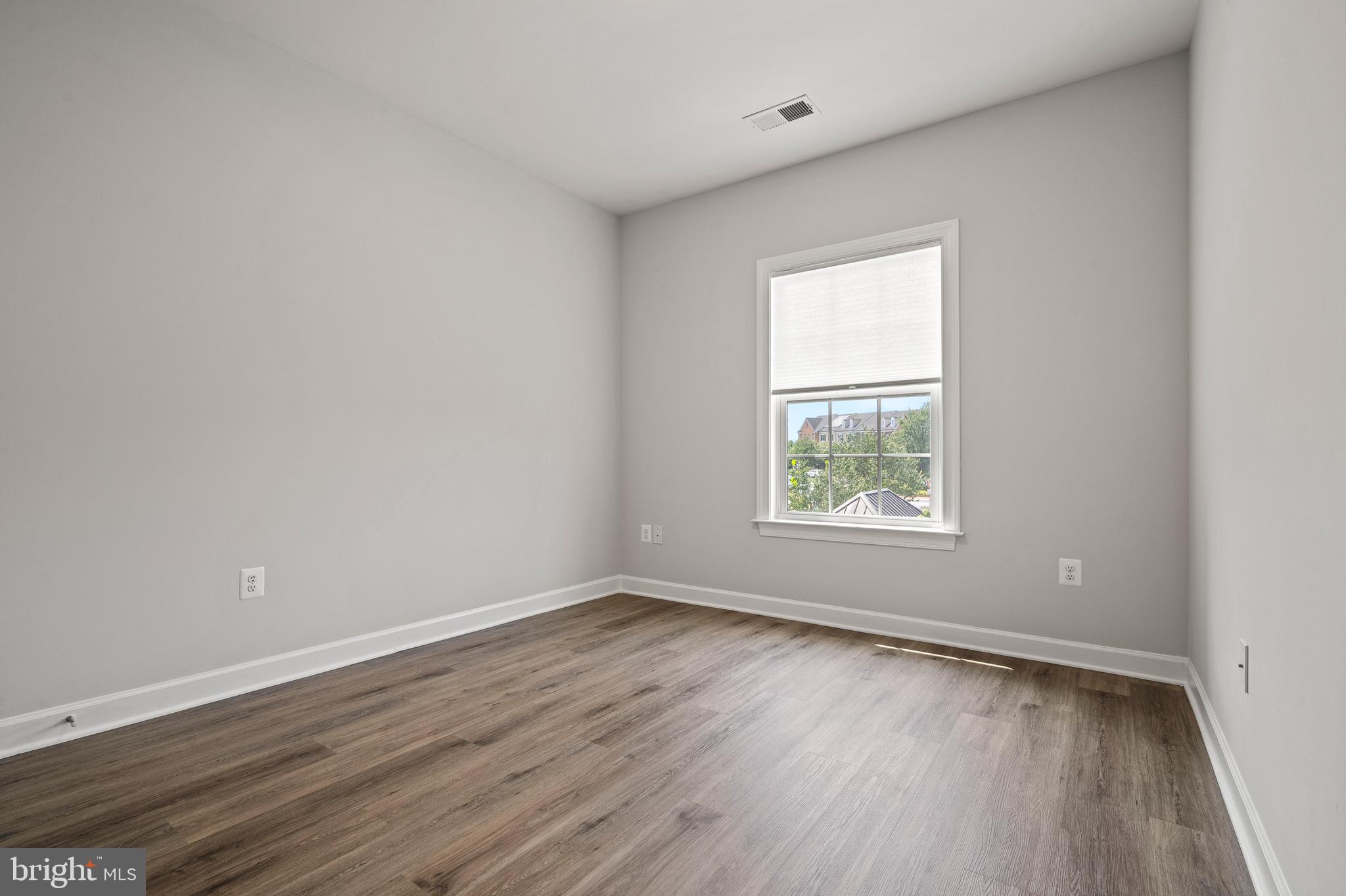 7704 Water Street Fulton, MD 20759 - Photo 30 of 45 an empty room with wooden floor and windows