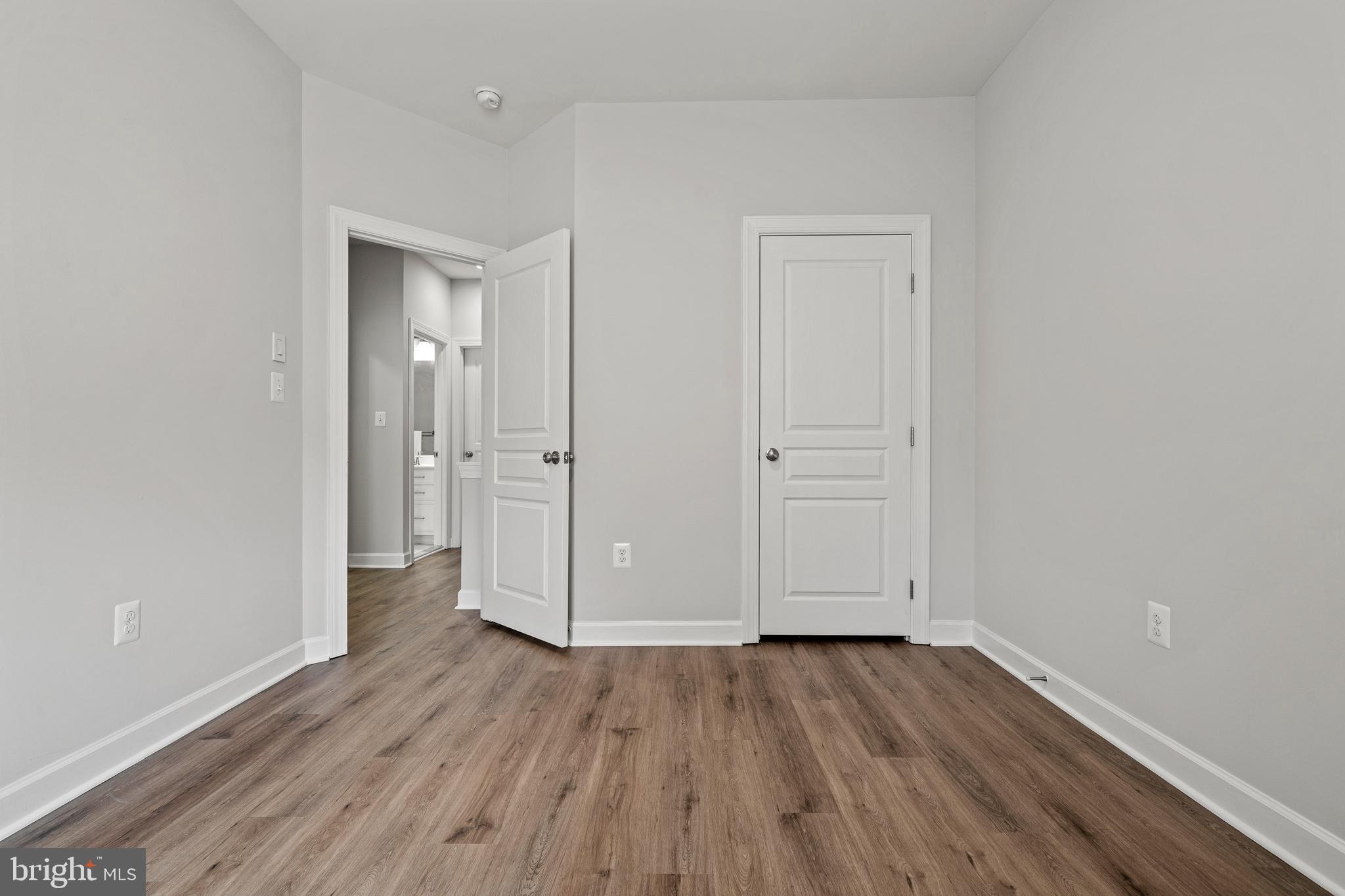 7704 Water Street Fulton, MD 20759 - Photo 31 of 45 wooden floor & wooden door in an empty room