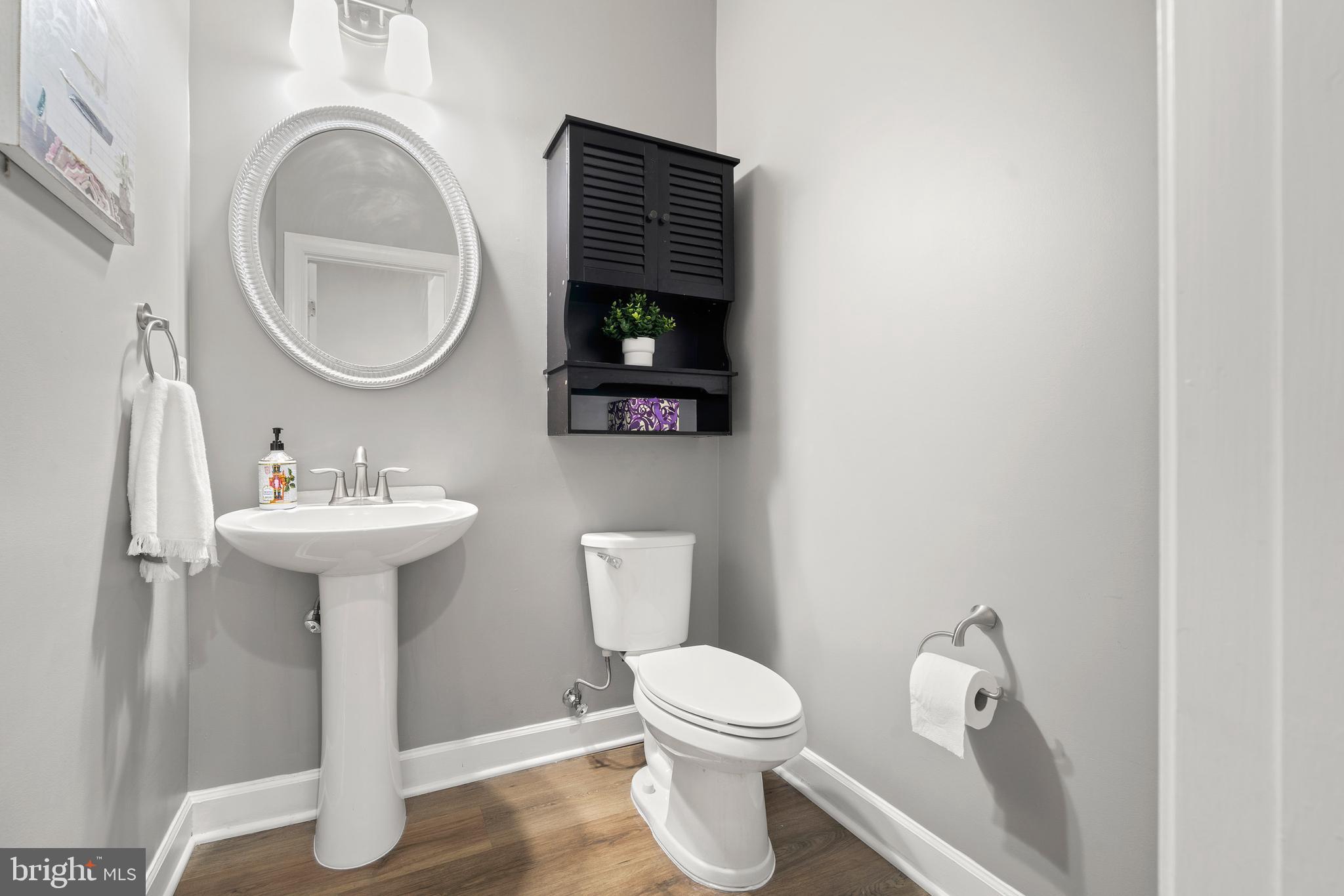 7704 Water Street Fulton, MD 20759 - Photo 40 of 45 a bathroom with a toilet a sink and a mirror