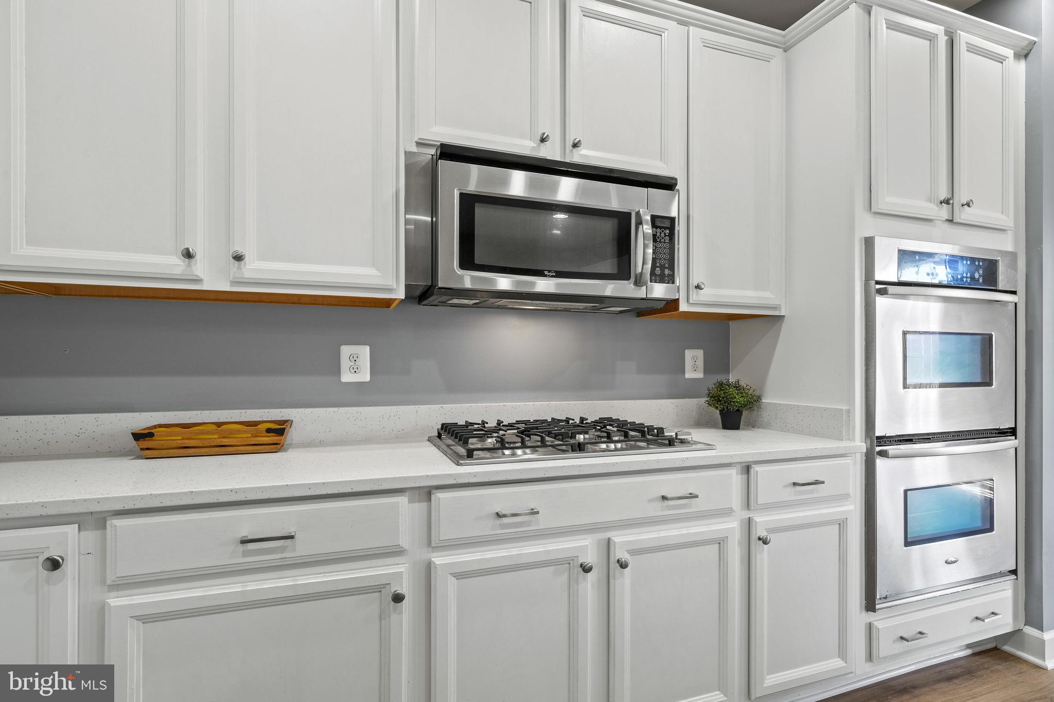 7704 Water Street Fulton, MD 20759 - Photo 6 of 45 a kitchen with white cabinets and appliances