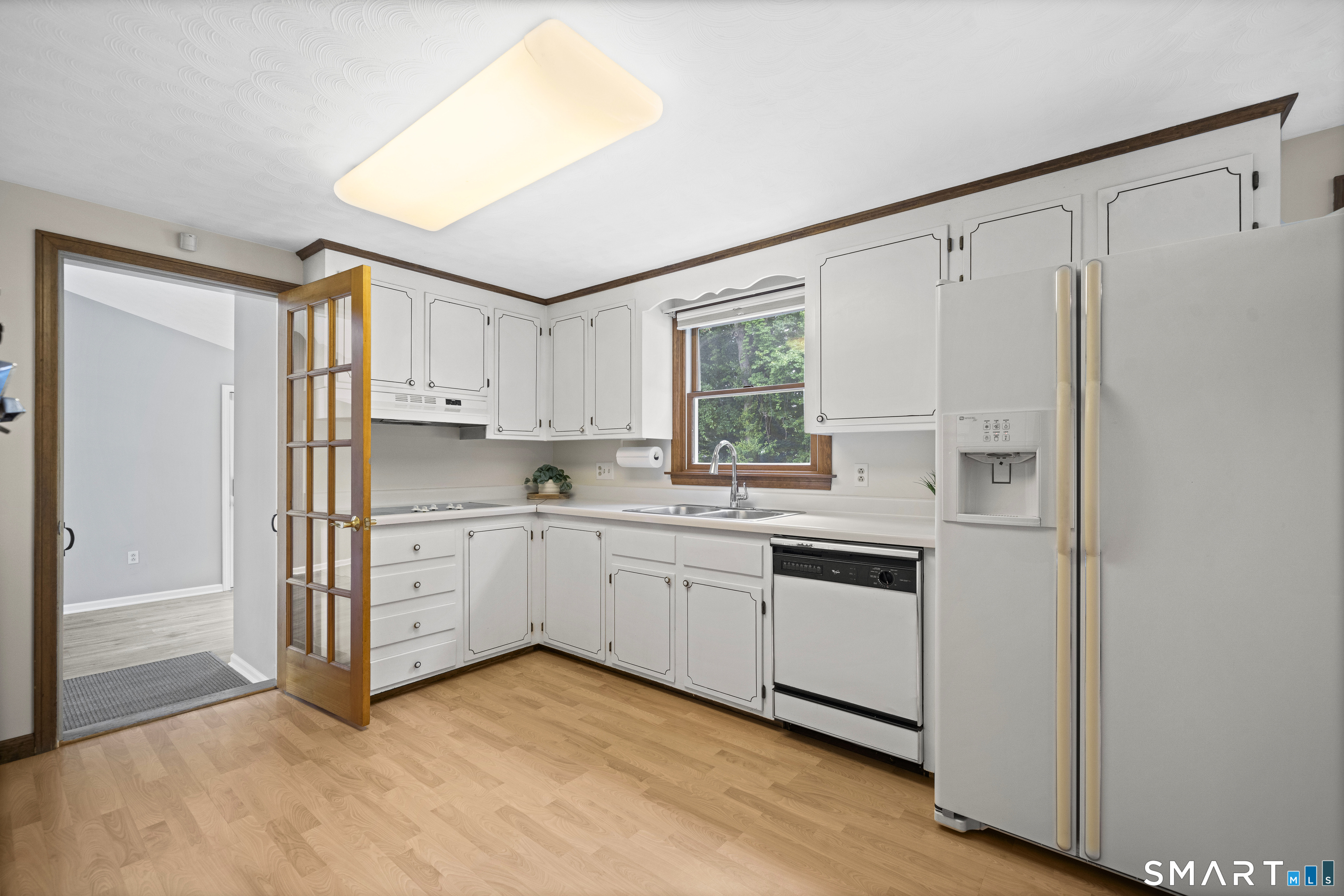 6 Cartier Road Enfield, CT 06082 - Photo 8 of 40 a kitchen with white cabinets and white appliances