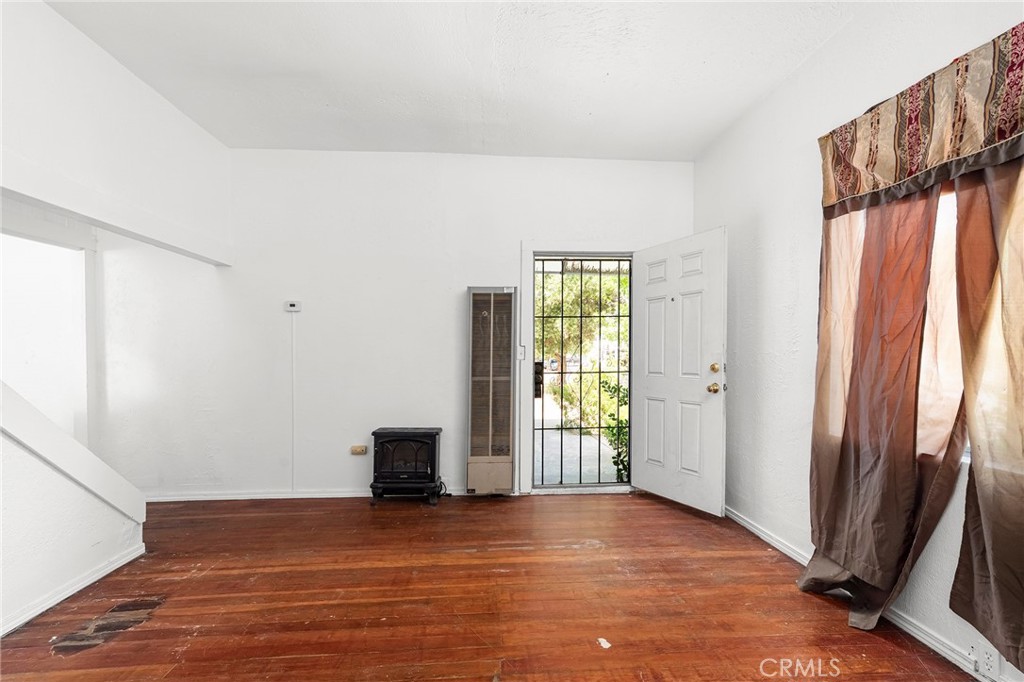 818 6th Street Corning, CA 96021 - Photo 7 of 32 a view of an empty room with window and wooden floor