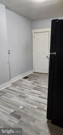 a view of a closet area with wooden floor