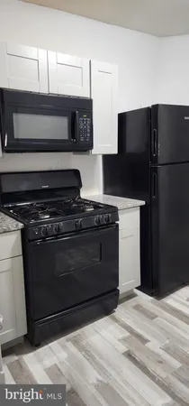 a kitchen with a stove and a refrigerator