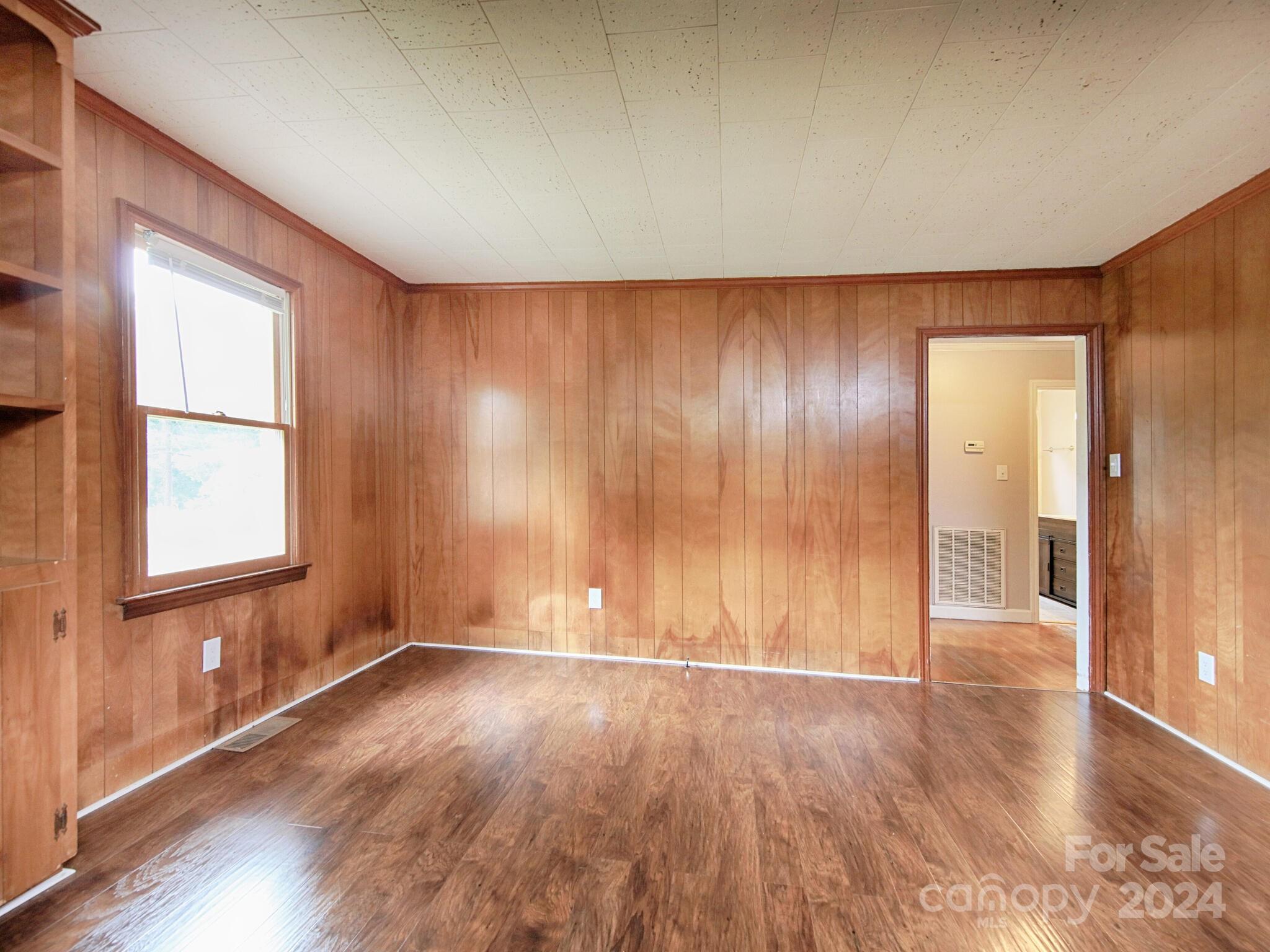 446 Fieldstone Road Mooresville, NC 28115 - Photo 12 of 30 an empty room with wooden floor and windows with curtains view