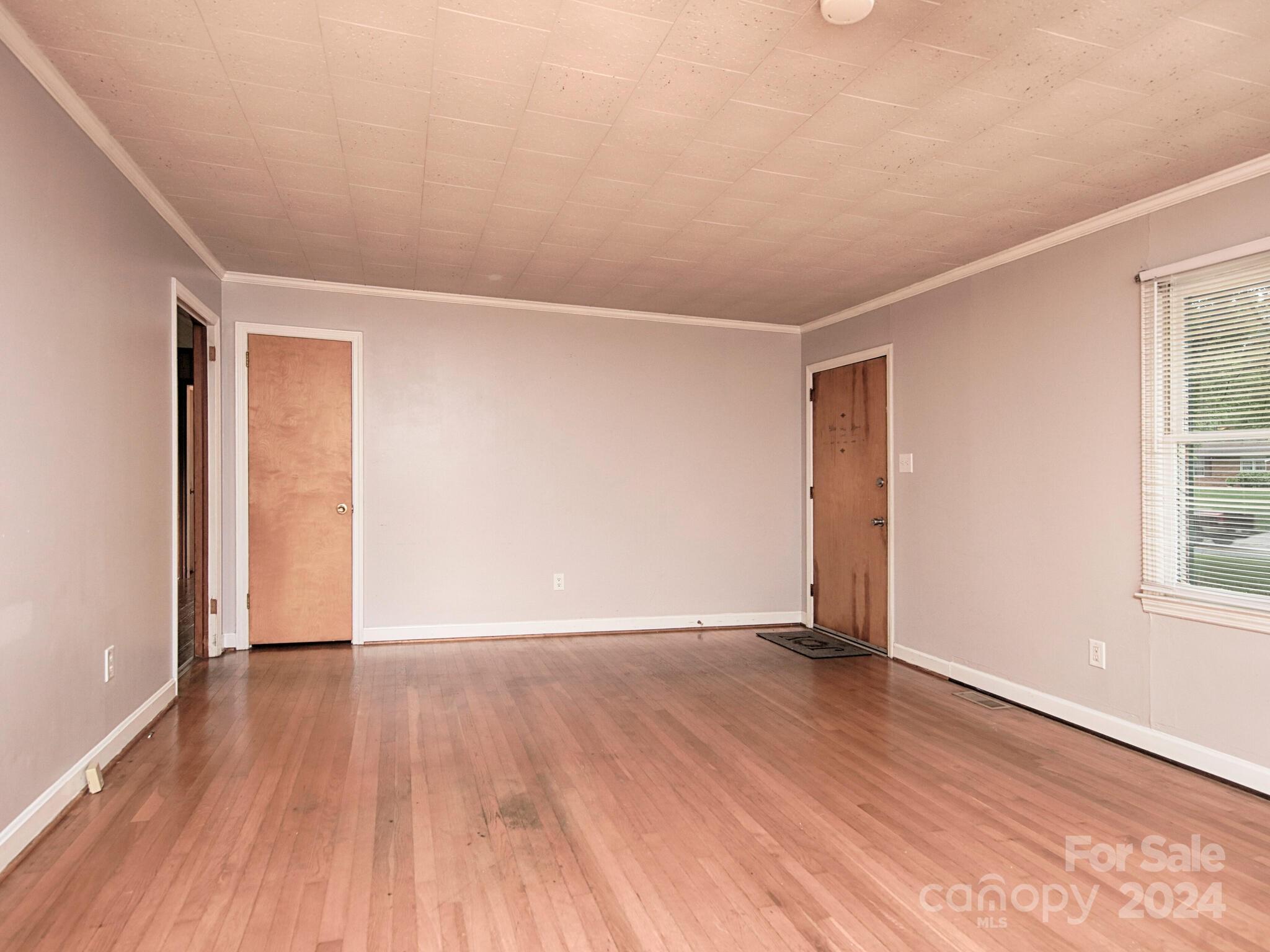 446 Fieldstone Road Mooresville, NC 28115 - Photo 5 of 30 a view of an empty room with wooden floor and a window