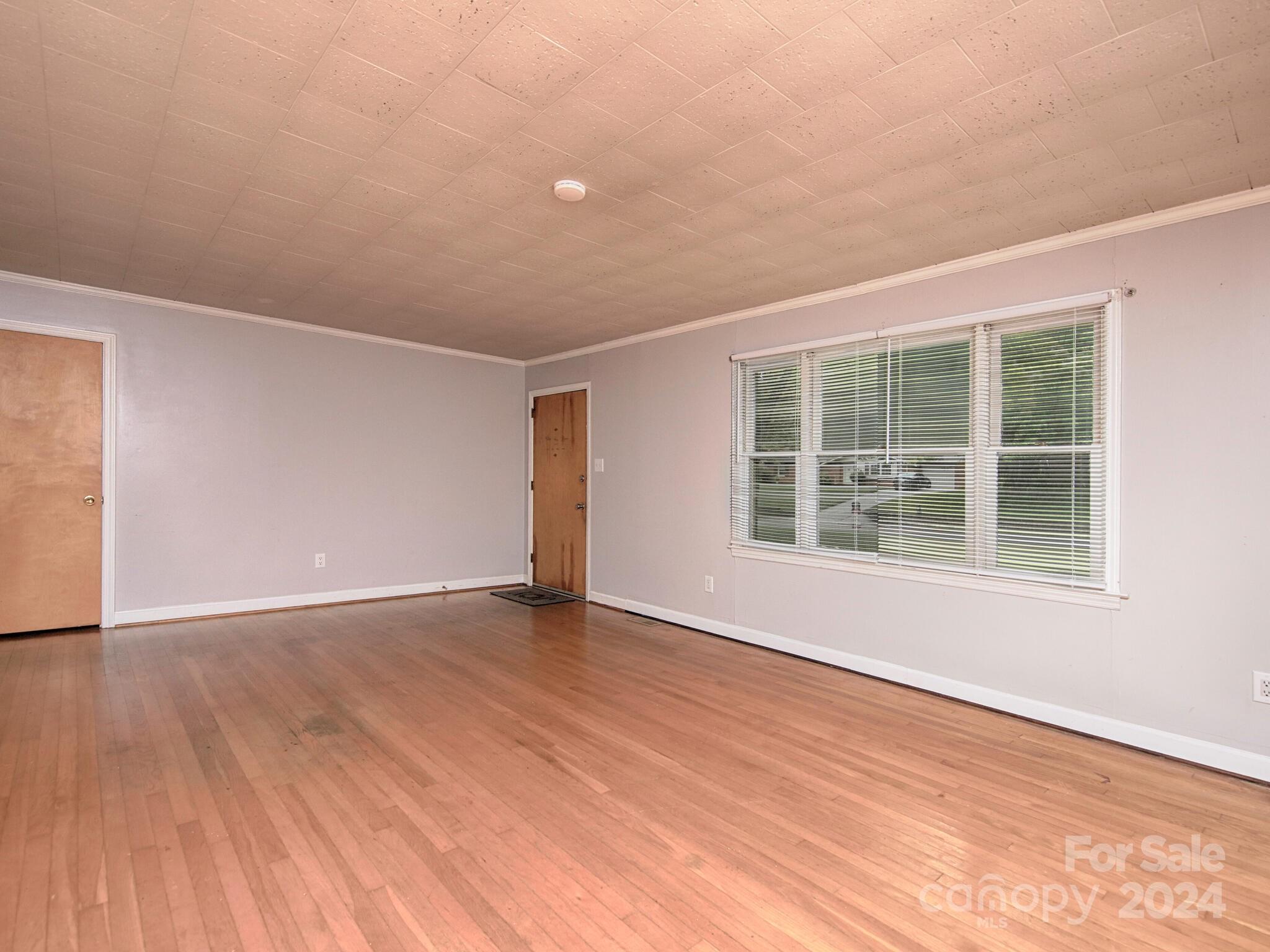446 Fieldstone Road Mooresville, NC 28115 - Photo 6 of 30 an empty room with wooden floor and windows
