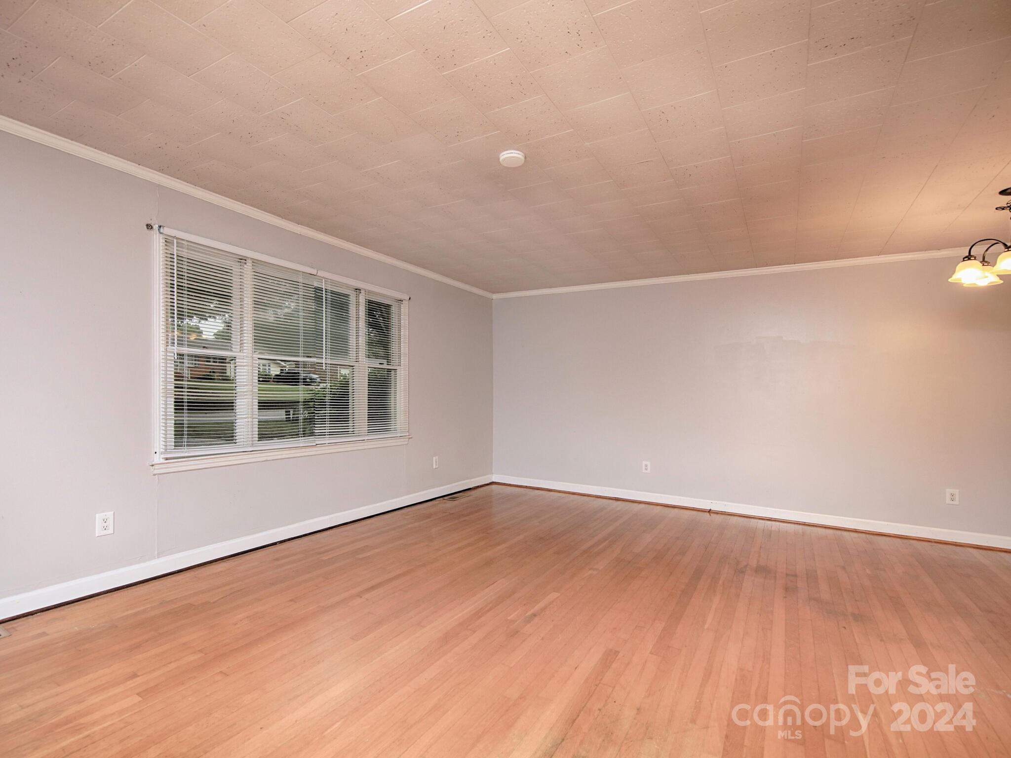 446 Fieldstone Road Mooresville, NC 28115 - Photo 7 of 30 an empty room with wooden floor and windows