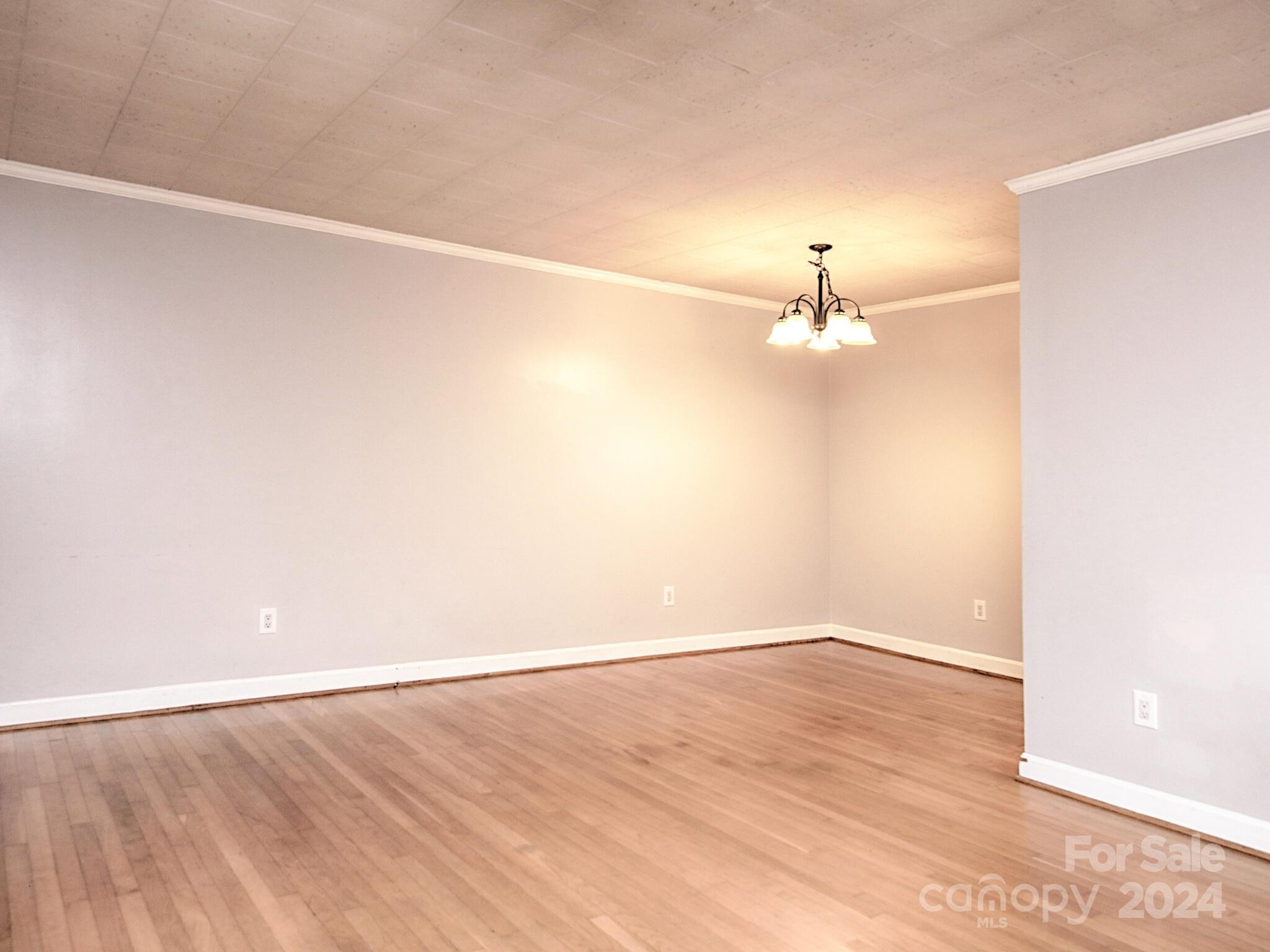 446 Fieldstone Road Mooresville, NC 28115 - Photo 8 of 30 an empty room with wooden floor and fan