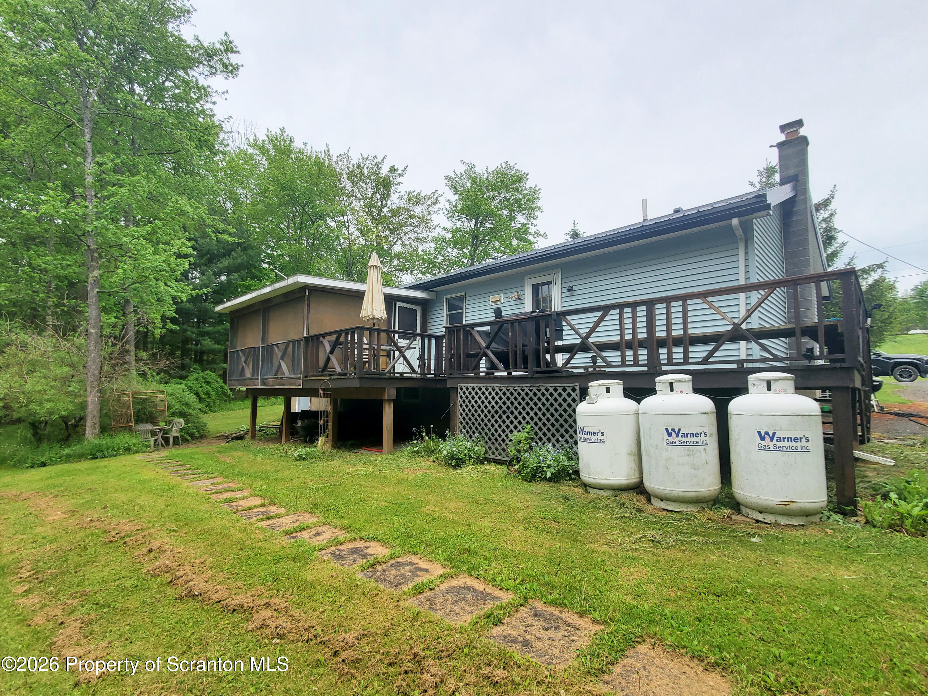 220 Brinkman Road Brackney, PA 18812 - Photo 7 of 32 a view of a house with backyard and sitting area