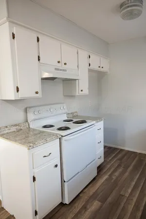 a view of cabinets with granite countertop