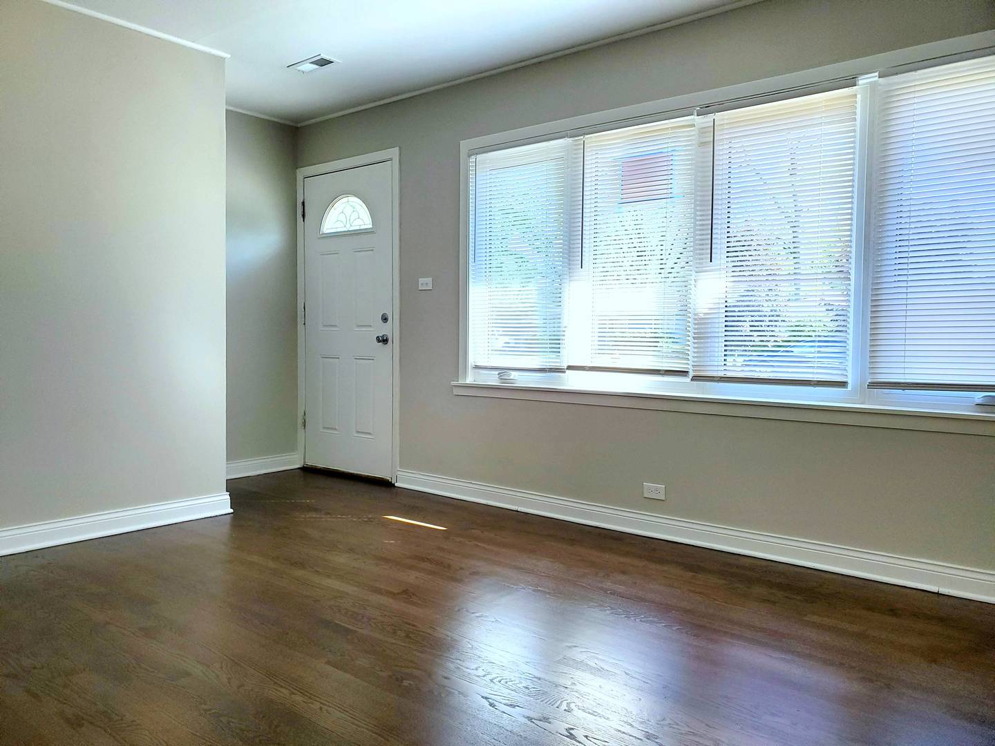 6106 Birmingham Street Chicago Ridge, IL 60415 - Photo 4 of 31 an empty room with wooden floor and windows