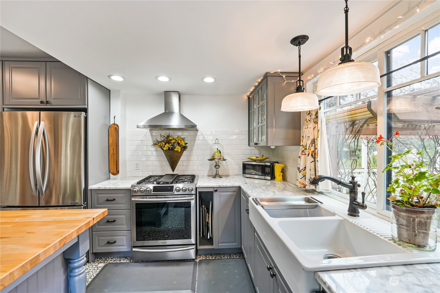 5918 Sunset Avenue Anacortes, WA 98221 - Photo 15 of 38 a kitchen that has a sink stainless steel appliances a counter space and a window