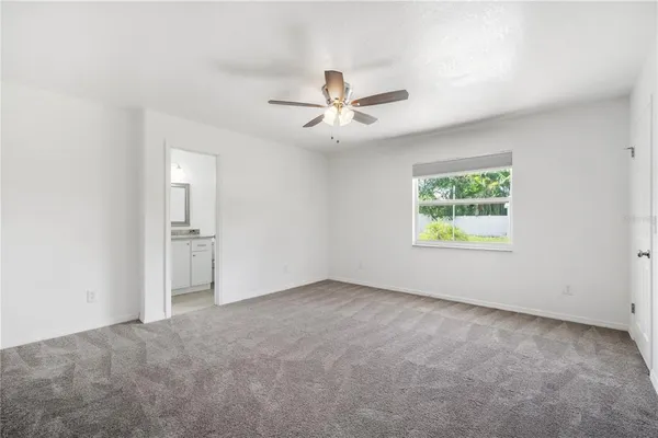 an empty room with a empty space and a ceiling fan