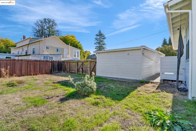 a backyard of a house with wooden floor and fence