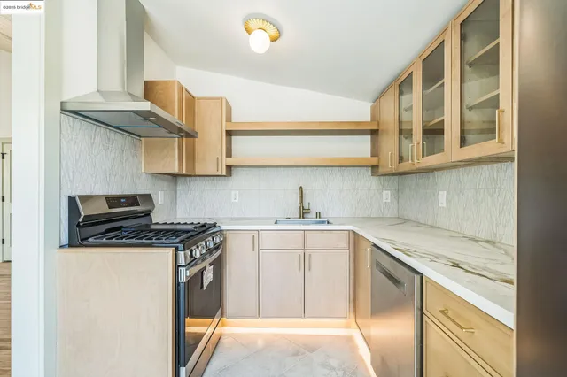 a view of a kitchen with a refrigerator and window