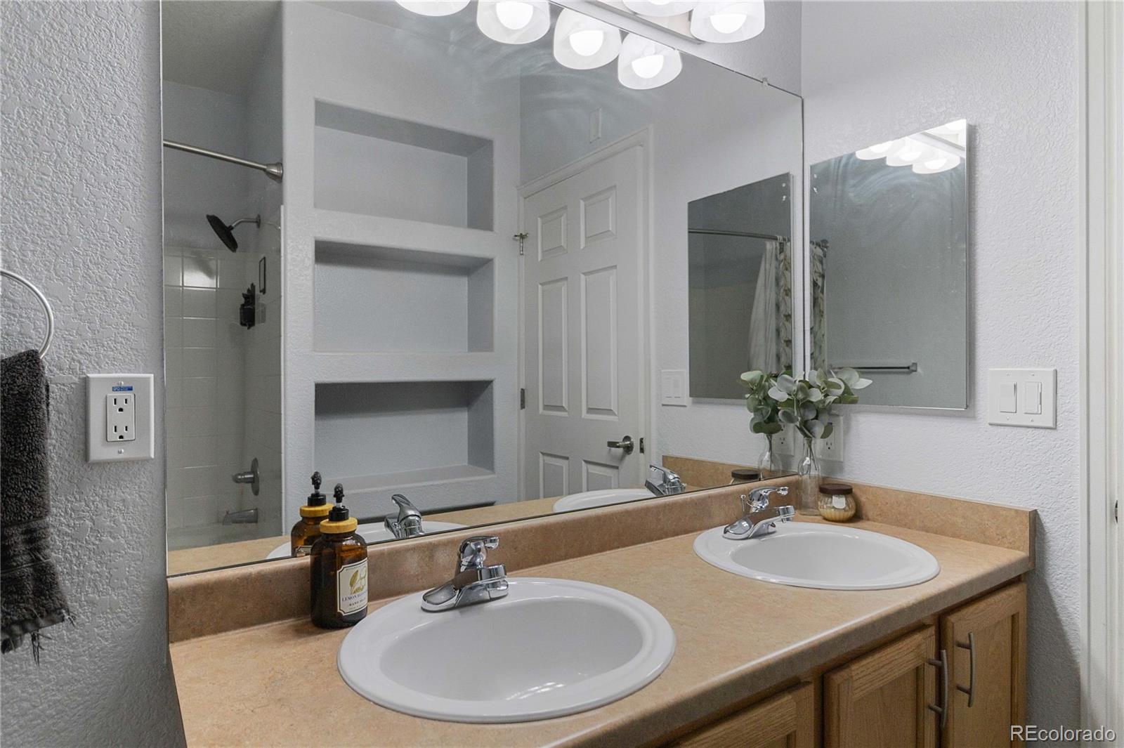 5255 Memphis Street, Unit 702 Denver, CO 80239 - Photo 18 of 30 a bathroom with a sink and a mirror