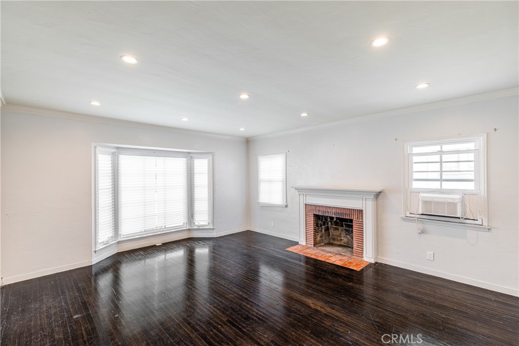 604 Grove Place Glendale, CA 91206 - Photo 23 of 30 an empty room with wooden floor fireplace and windows