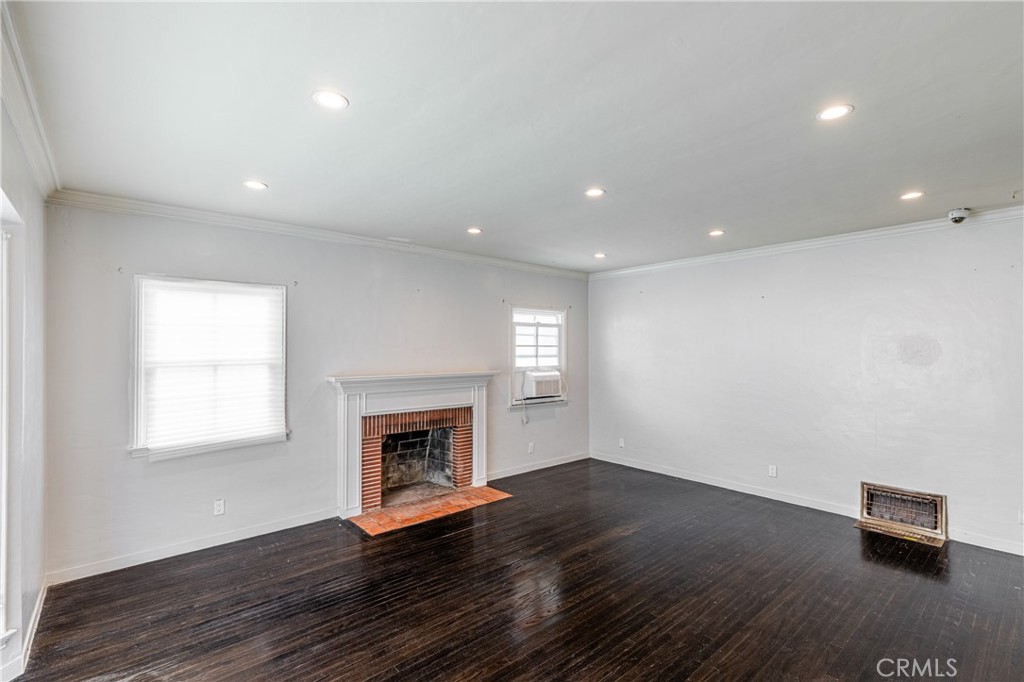 604 Grove Place Glendale, CA 91206 - Photo 24 of 30 an empty room with wooden floor and a fireplace