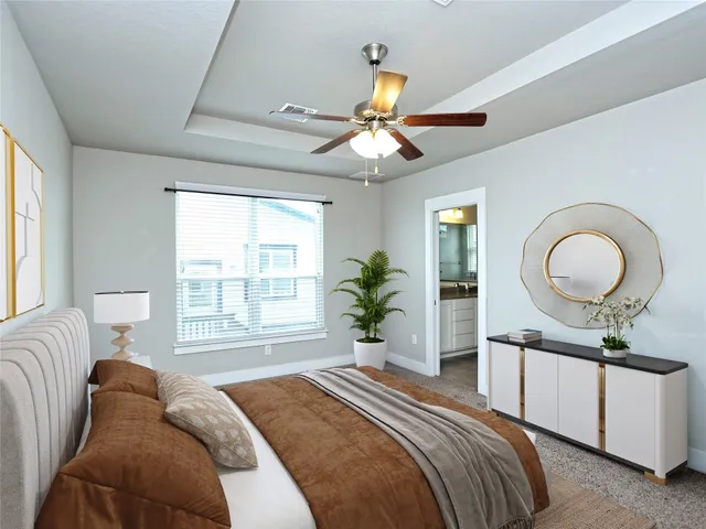a bedroom with a bed dresser and a chandelier