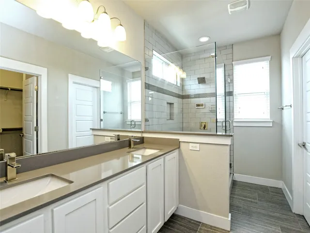 a bathroom with a granite countertop sink mirror and double