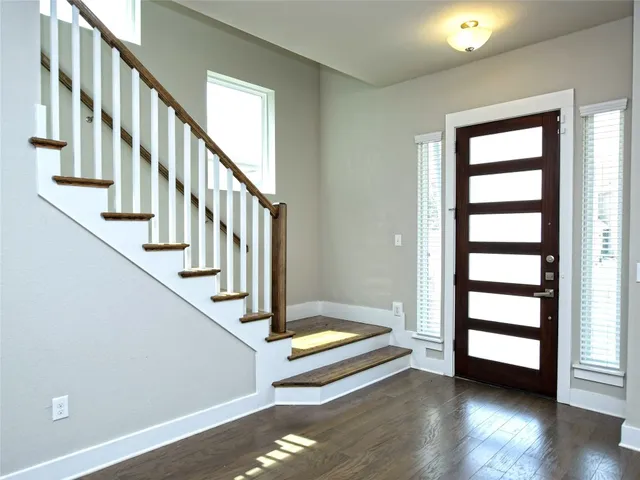 a view of an entryway with wooden floor