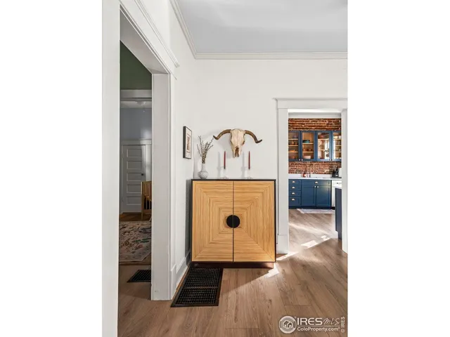 a living room with furniture a rug and a lamp