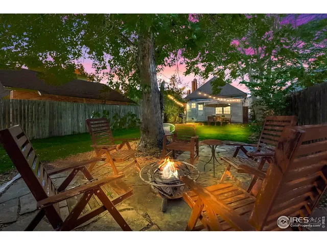 a view of a chairs and table in backyard of the house