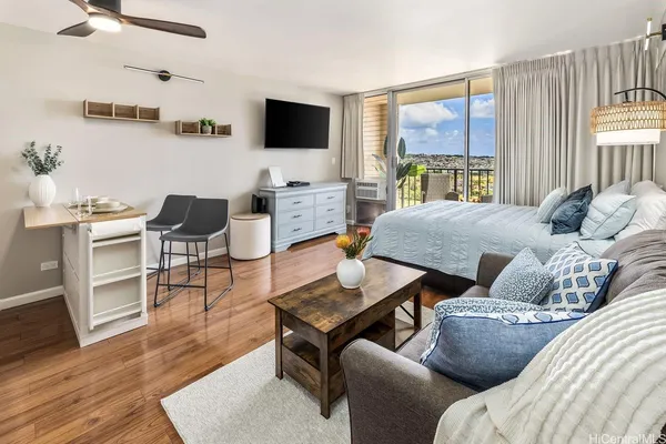 a living room with furniture and a floor to ceiling window