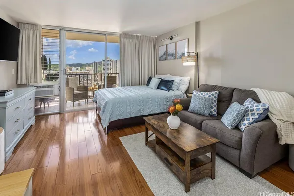 a bedroom with a large bed and a wooden floor