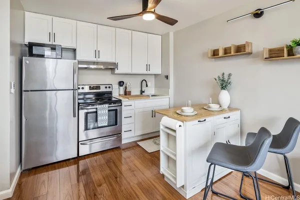 a kitchen with a stove a sink and a refrigerator