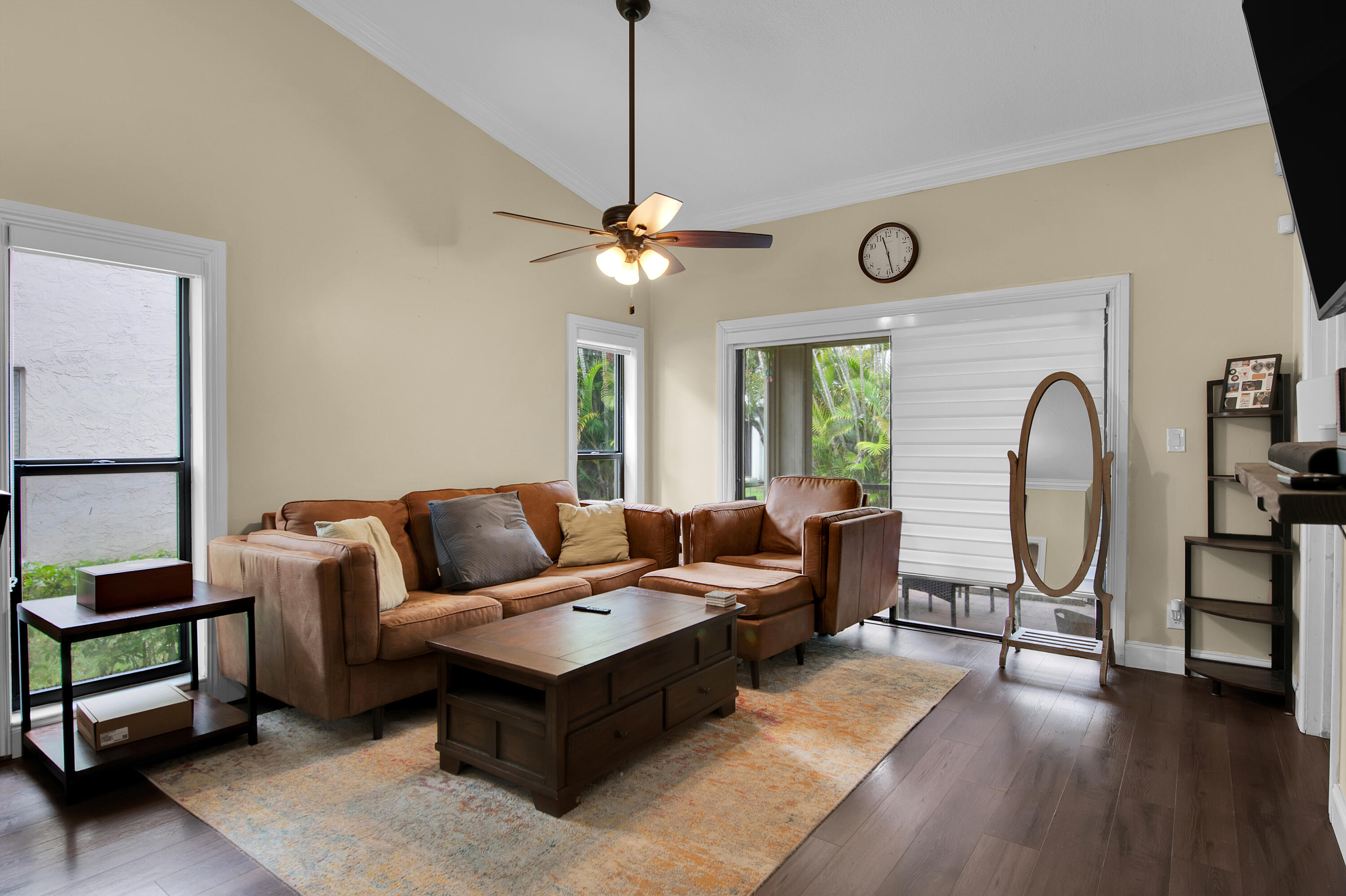 8203 Northwest 100th Way Tamarac, FL 33321 - Photo 12 of 31 a living room with furniture a ceiling fan a lamp and a window