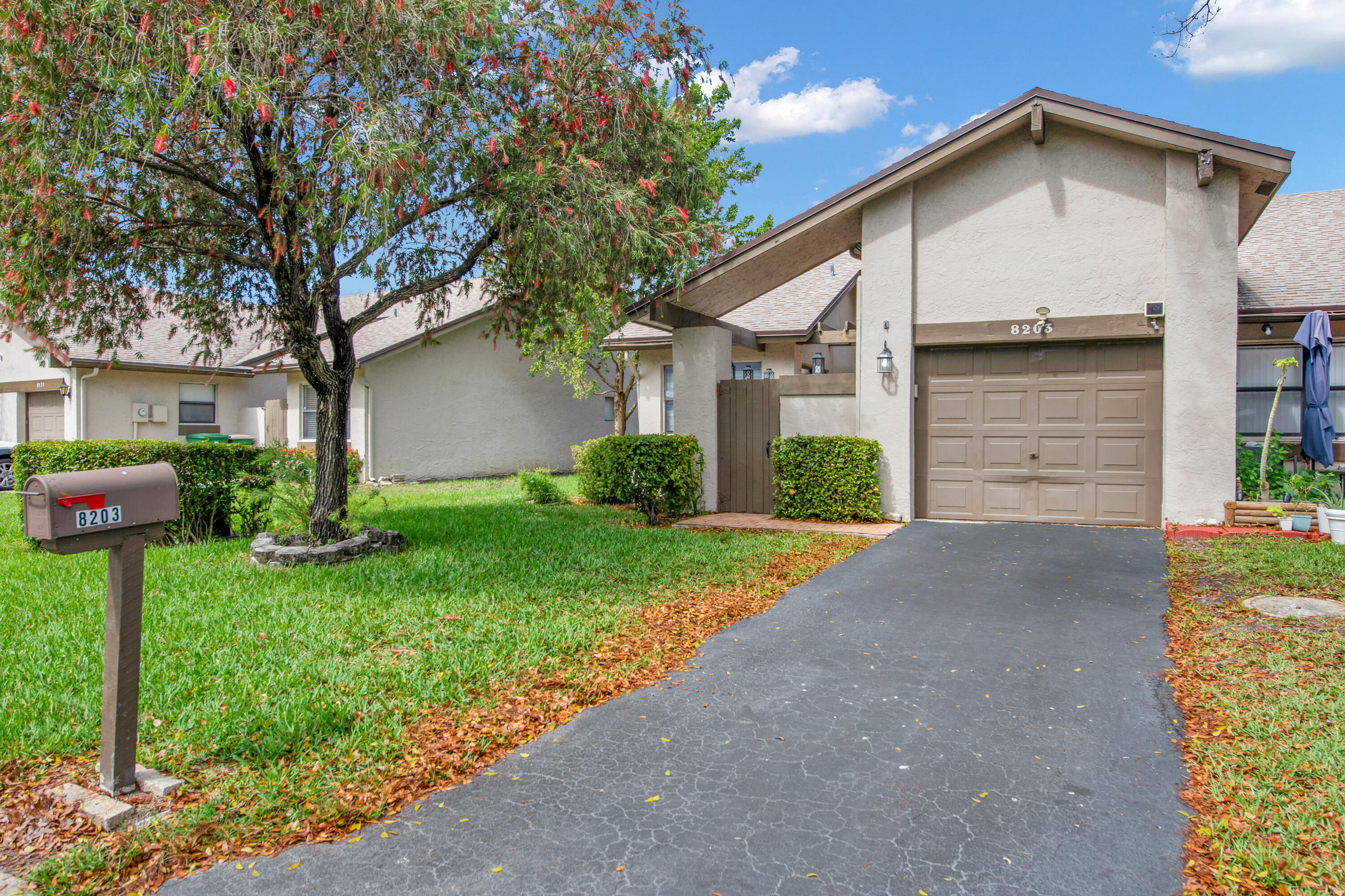 8203 Northwest 100th Way Tamarac, FL 33321 - Photo 5 of 31 a front view of a house with garden