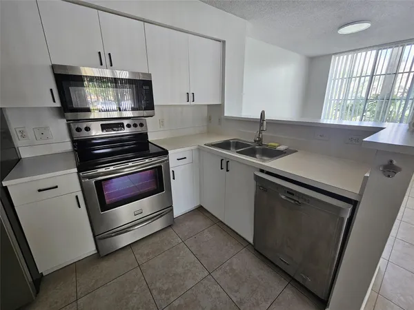 a kitchen with appliances and cabinets