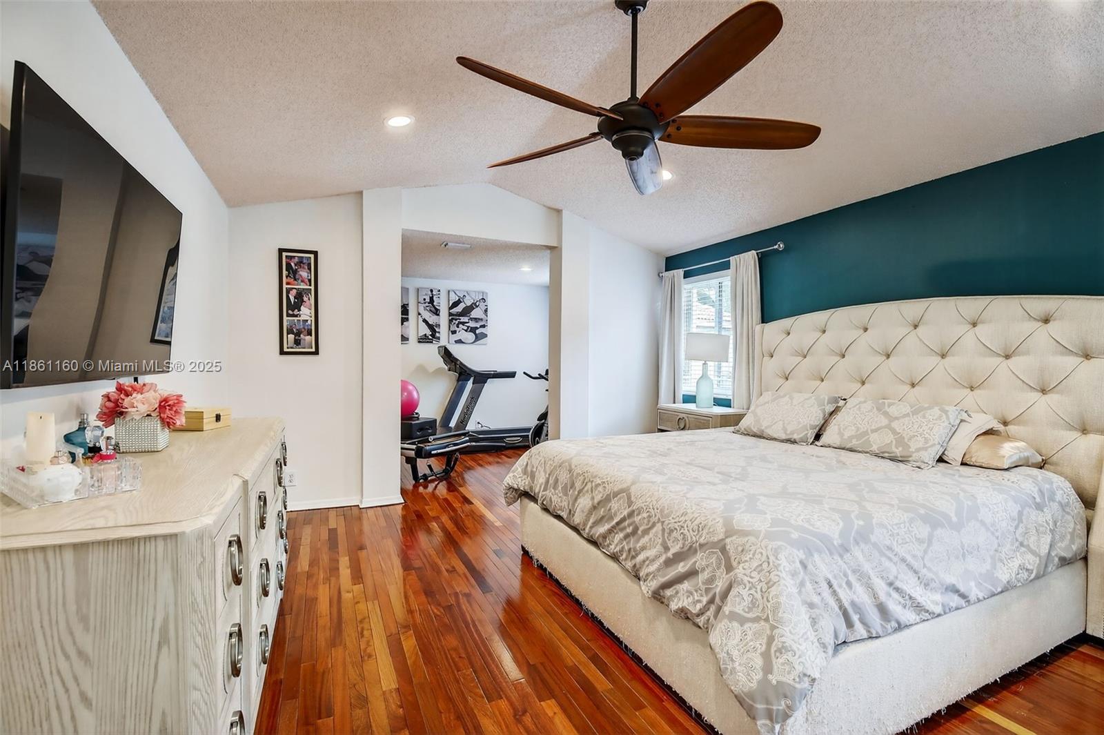 3989 Pinewood Lane Weston, FL 33331 - Photo 16 of 53 a bedroom with a bed and a flat screen tv