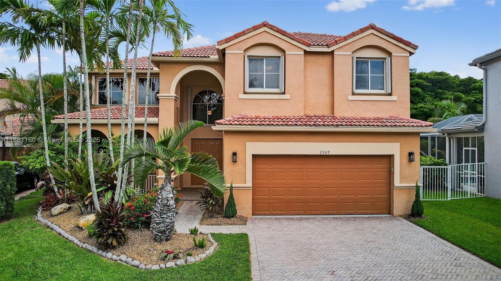 3989 Pinewood Lane Weston, FL 33331 - Photo 39 of 53 a front view of a house with garden