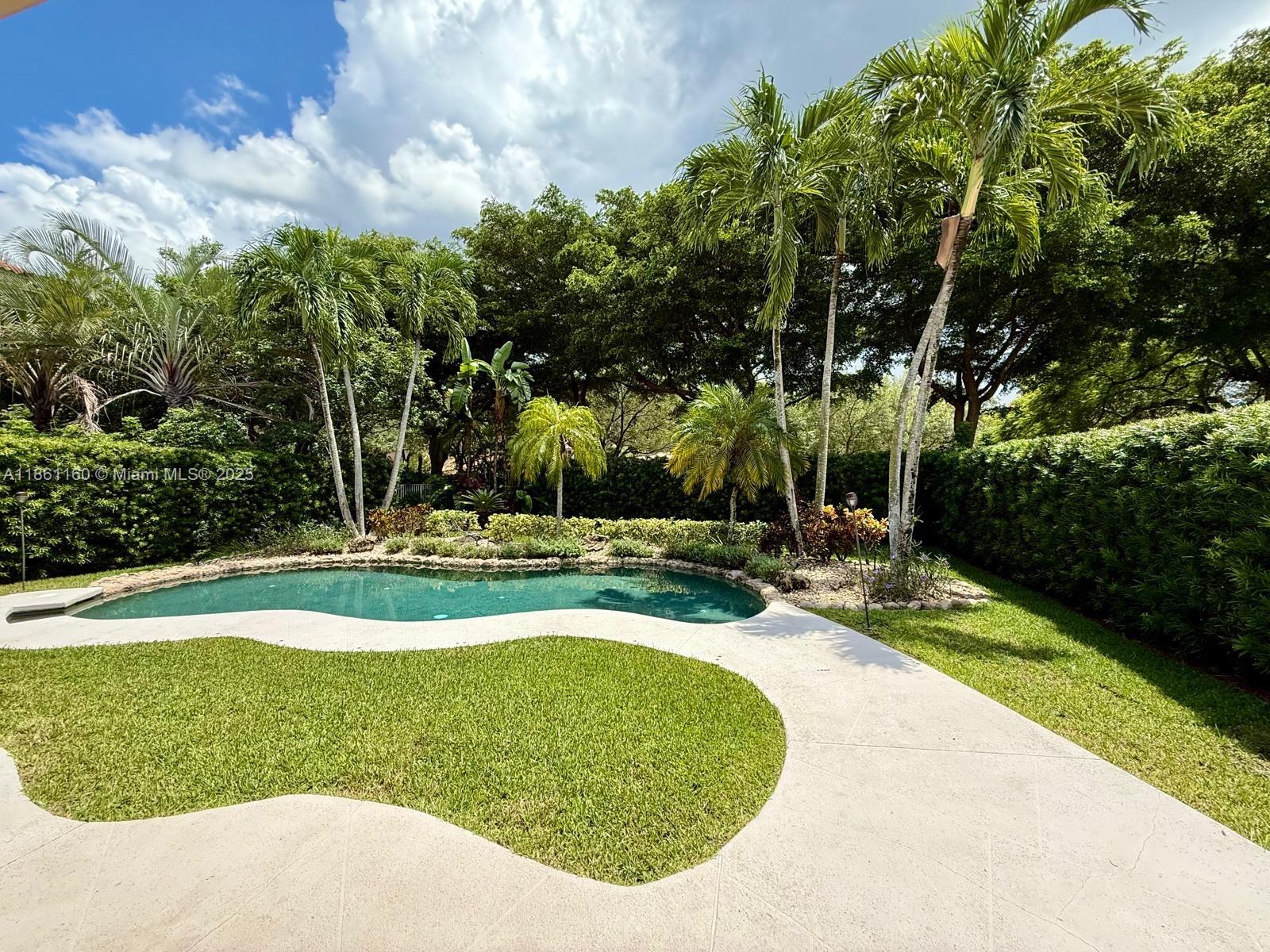 3989 Pinewood Lane Weston, FL 33331 - Photo 52 of 53 a view of a swimming pool with a yard