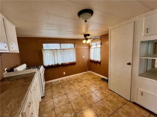 a kitchen with a refrigerator sink and cabinets