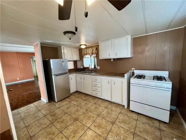 a bathroom with a granite countertop toilet and a shower